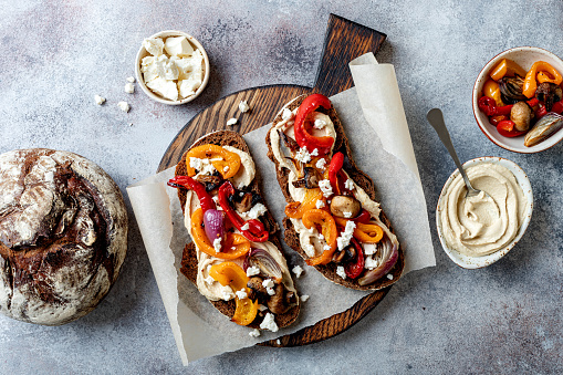Roasted vegetables toast with hummus and feta cheese