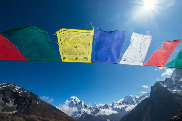 istock Holy buddhist praying multicolored flags with mantras flapping and waving on the  strong wind with valley view and Ama Dablam 6812m peak.Everest Base Camp trekking route near Dughla 4620m. 1204498108