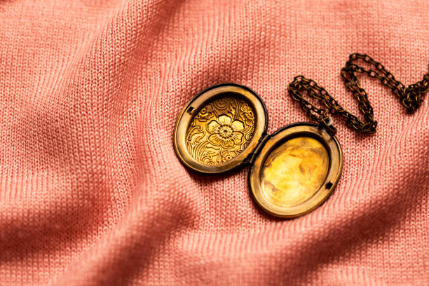 vintage grandma's bronze locket on a pink fabric background