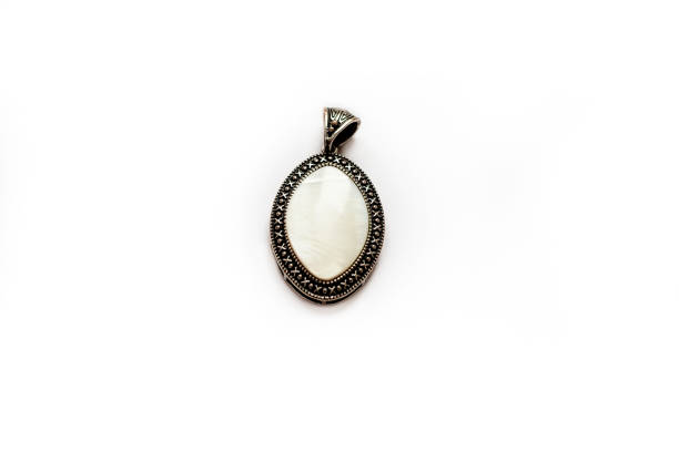 istock vintage grandma's medallion with white nacre gemstone isolated on a white background 1204500234