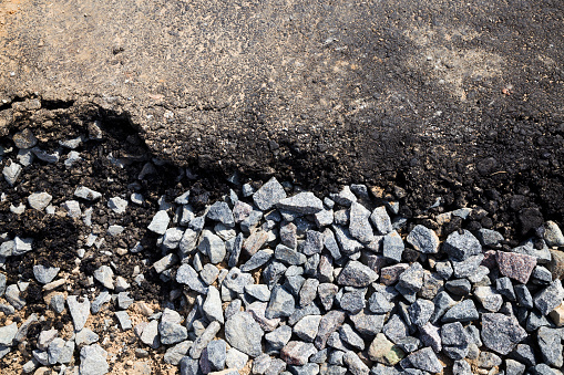 small rubble and a layer of asphalt at the construction site of a new highway or roadway, top