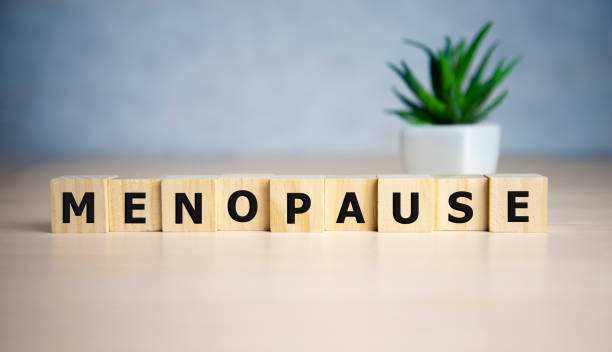 menopause word written on wood block. menopause text on table, concept.