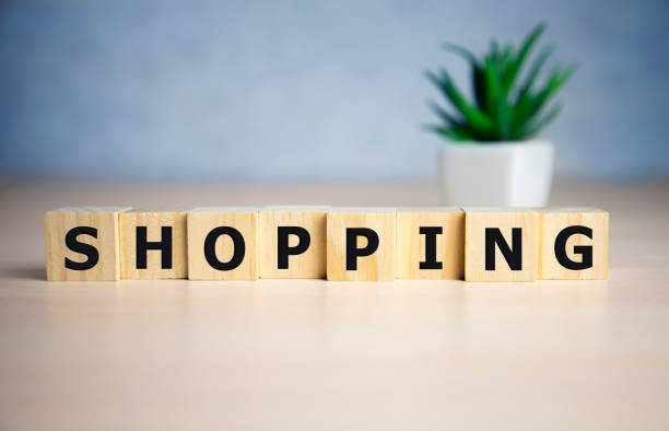 istock Shopping word, word cube with blue background 1204505969