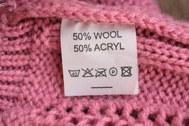 istock Wrong side of a pink knitted sweater made of wool, the composition is specified: 50% wool and 50% acryl. 1204507254