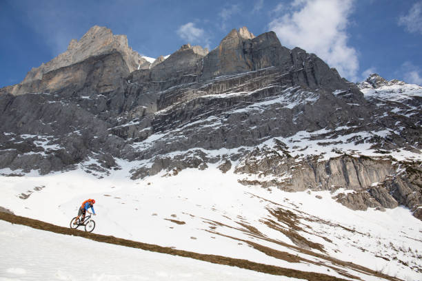 istock Mountain biker descends steep mountainside 1204510741