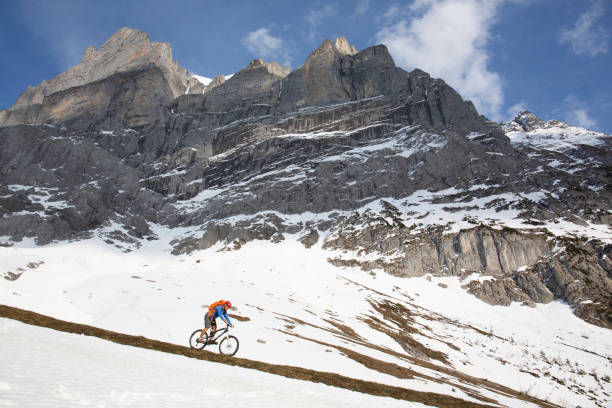 istock Mountain biker descends steep mountainside 1204510789