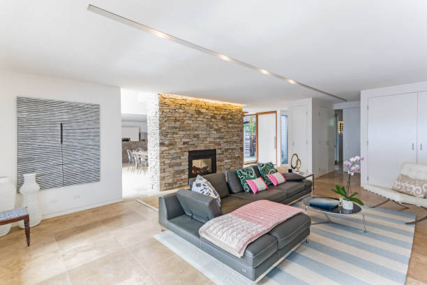 istock Stone wall fireplace in a modern lounge room 1204512921