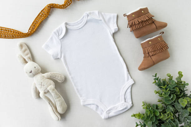Gender Neutral Blank White Baby Bodysuit Flat lay Mockup - Baby Clothing Mock Up - Styled Stock Photography Baby Clothing Mock Up gender neutral photos stock pictures, royalty-free photos & images