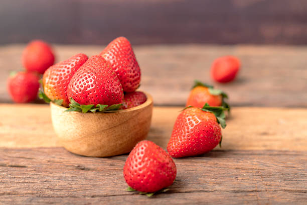 Freshness ripe strawberries are in a wooden bowl