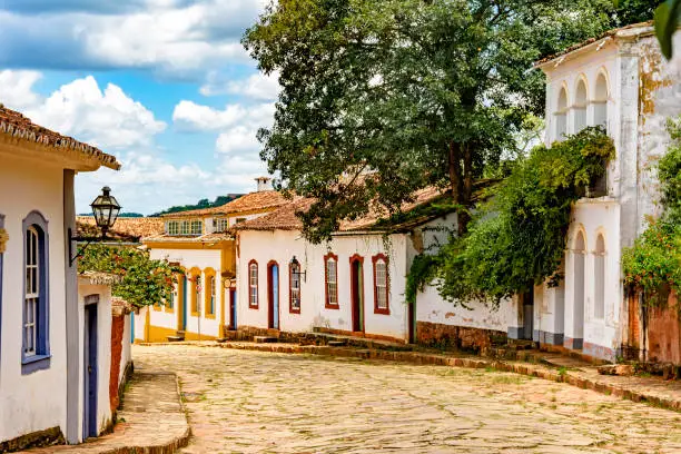 Street with cobblestones and some houses with colonial architecture in the old and historic city of Tiradentes
