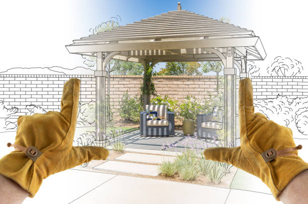 Male Contractor Hands Framing Completed Section of Custom Pergola Patio Cover Design Drawing Male Contractor Hands Framing Completed Section of Custom Pergola Patio Cover Design Drawing. construction equipment photos stock pictures, royalty-free photos & images