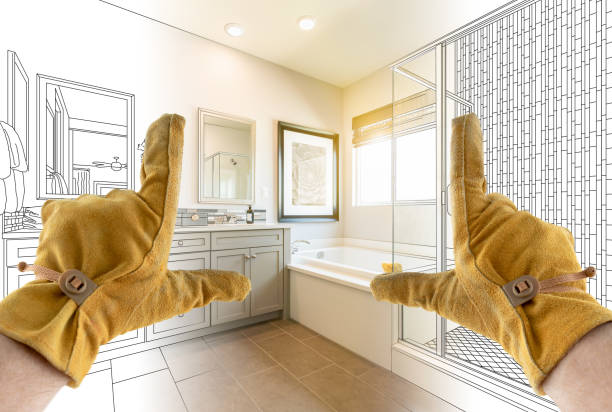 istock Male Contractor Hands Framing Completed Section of Bathroom Over Bathroom Drawing 1204515947