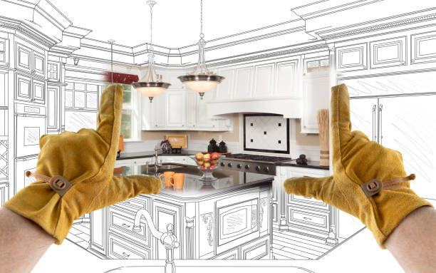 istock Male Contractor Hands Framing Completed Section of Custom Kitchen Design Drawing 1204515959