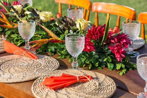 istock Place setting sunny tropical themed wedding table with rattan charger 1204518326