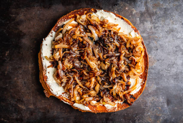 Homemade pizza with goat cheese, caramelized onion and balsamic vinegar
