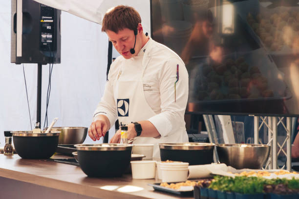 June 1, 2019 Festivities in the city on the day of Swedish culture June 1, 2019 Festivities in the city on the day of Swedish culture Cook prepare food on a demonstration advertising campaign cooking show stock pictures, royalty-free photos & images