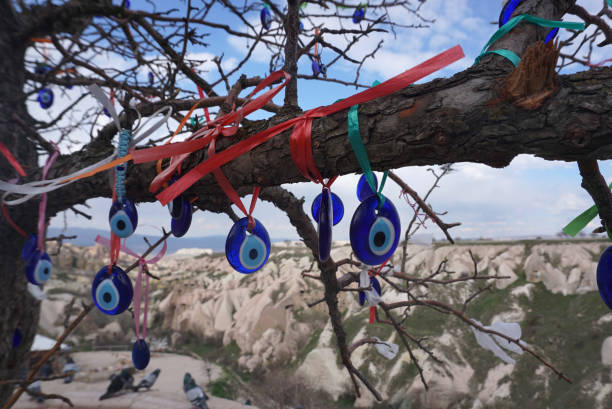 istock Turkey blue evil eye charm hanging on the tree with blue sky 1204535415
