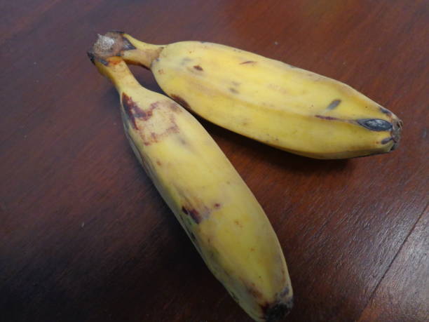 istock Yellow ripe bananas on a brown table 1204540030