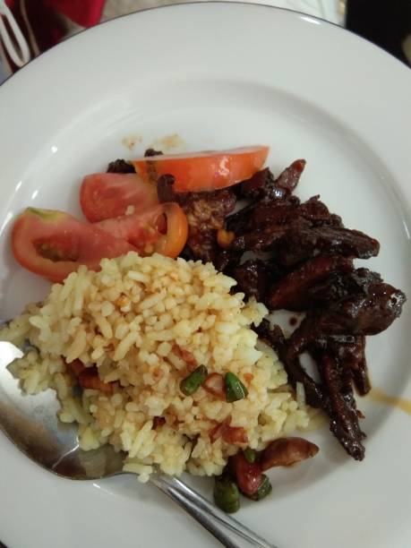 istock goat roll with yellow rice and tomatoes 1204540964
