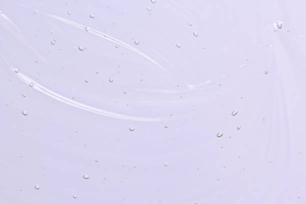 istock Face serum, light purple liquid gel cream texture 1204547041