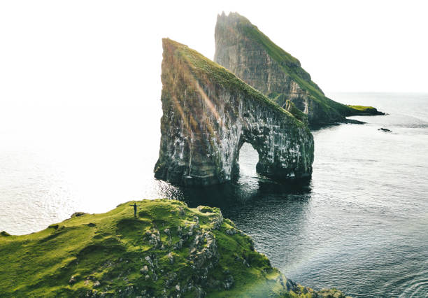 istock man with arm raisd camping at the faroe islands 1204548068