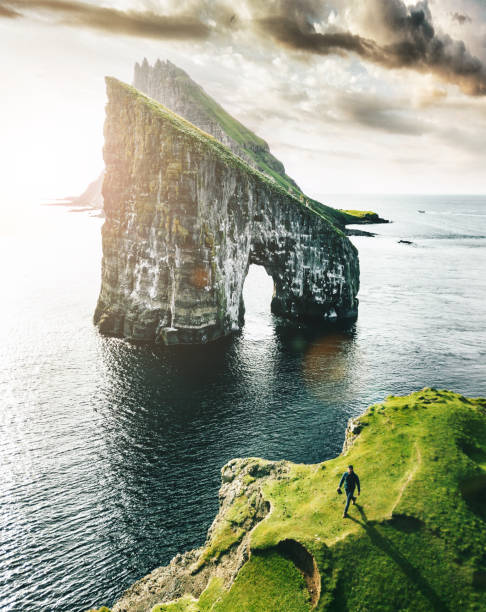 istock man with arm raisd camping at the faroe islands 1204548088