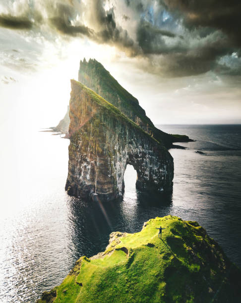 istock man with arm raisd camping at the faroe islands 1204548169
