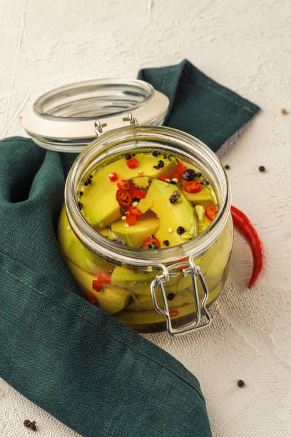 istock Fermented avocado vegetables with red chili peppers. 1204550321