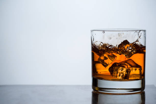 istock Whiskey in a glass with ice. 1204551000