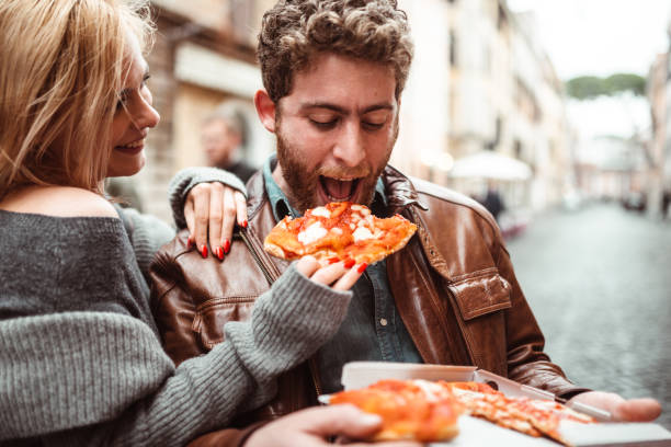 istock friends eating a pizza in italy 1204556056