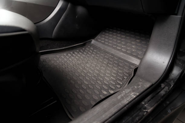 Dirty car floor mats of black rubber under passenger seat in the workshop for the detailing vehicle before dry cleaning. Auto service industry. Interior of sedan. Dirty car floor mats of black rubber under passenger seat in the workshop for the detailing vehicle before dry cleaning. Auto service industry. Interior of sedan. mat stock pictures, royalty-free photos & images