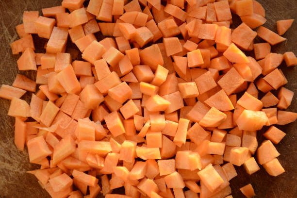 istock Fresh carrot on a light wooden table. 1204559128