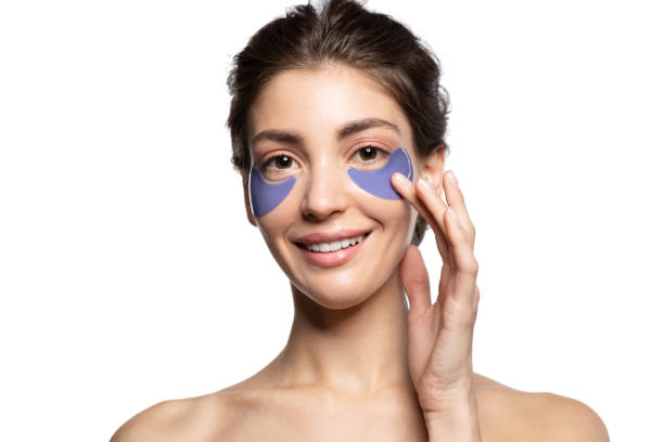 istock Charming girl applying patches under eyes portrait 1204564688