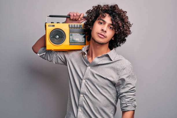 istock Student with music beat box on isolated gray background 1204565782