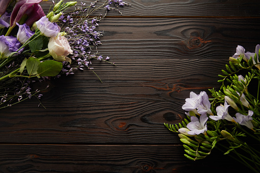 top view of violet and purple floral bouquets on wooden table