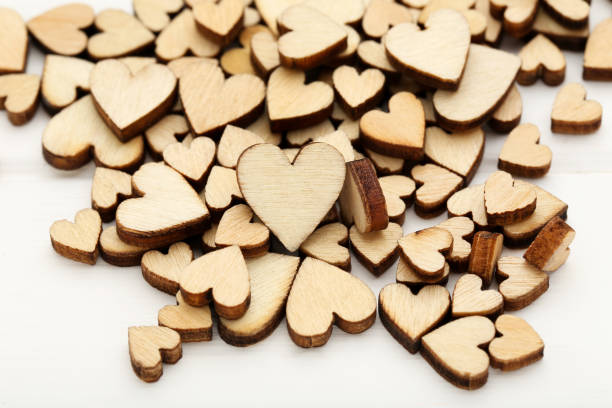 istock Brown hearts on white wooden table 1204569071