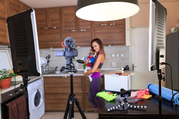 istock Female vlogger filming a pet video 1204572743