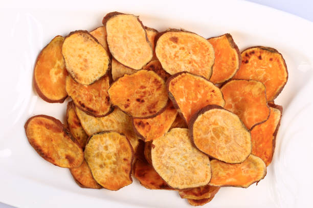 istock Healthy sweet potato chips  isolated on white background 1204573584