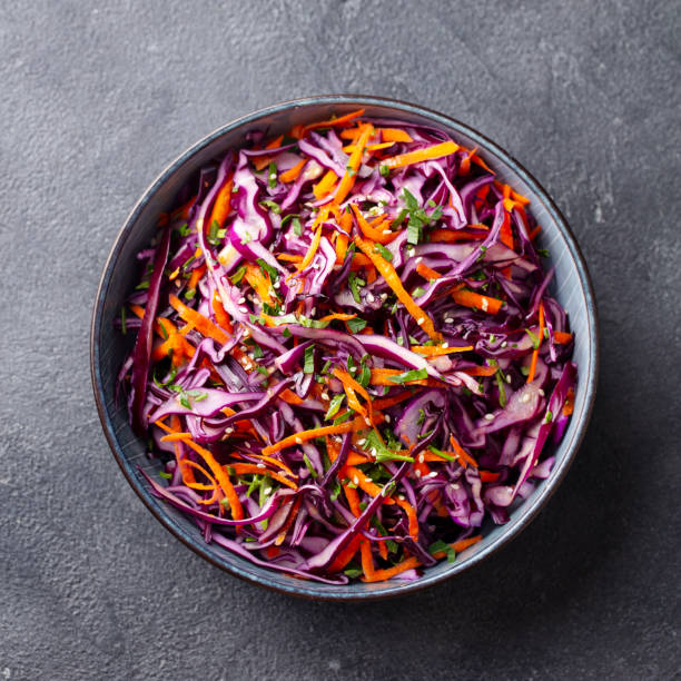 istock Red cabbage salad, Coleslaw in a bowl. Grey background. Close up. Top view. 1204575235