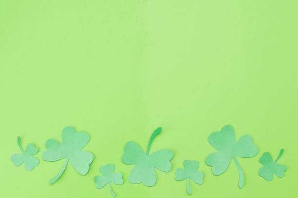 istock Green Clovers on Green Background Background for St. Patrick's Day Holiday 1204575242