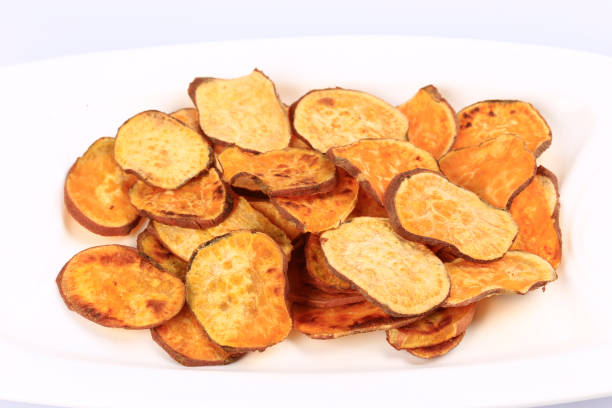 istock Healthy sweet potato chips  isolated on white background 1204576988