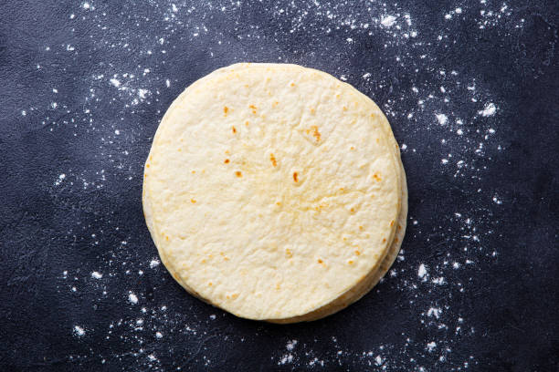 Tortillas, flat breads on dark grey background. Copy space. Top view.