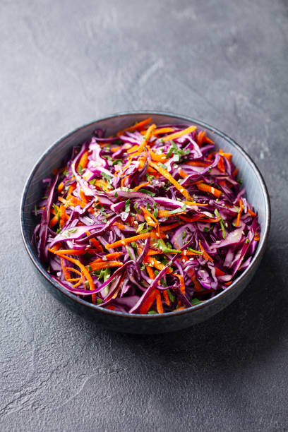 istock Red cabbage salad, Coleslaw in a bowl. Grey background. 1204577388