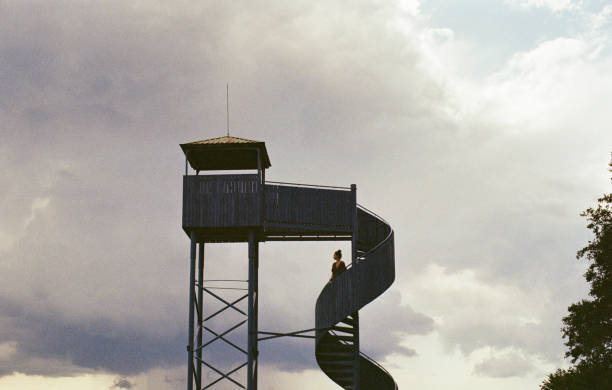 Young Caucasian woman standing on lookout  tower