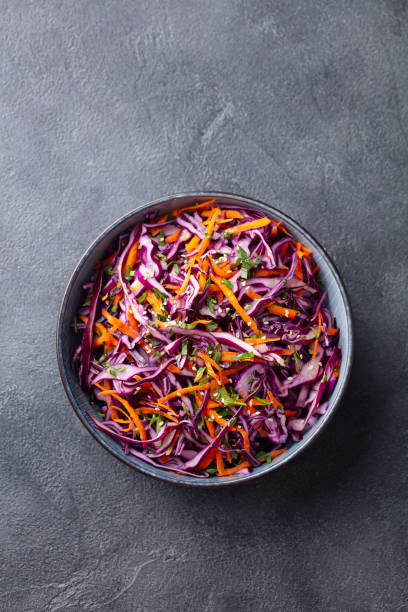 istock Red cabbage salad, Coleslaw in a bowl. Grey background. Top view. Copy space. 1204577811