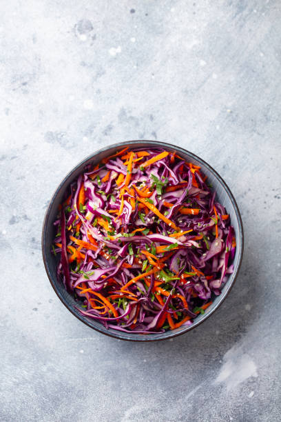 istock Red cabbage salad, Coleslaw in a bowl. Grey background. Top view. Copy space. 1204578737