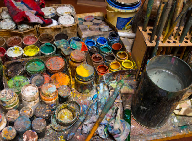 istock Artistic paintbrushes, paints and palette knifes 1204579875