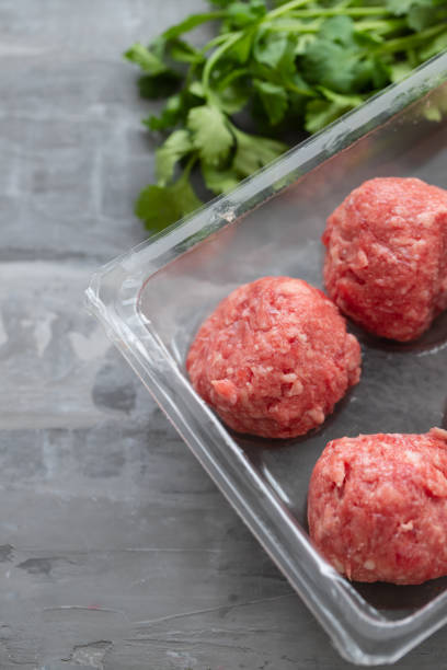 istock raw meatballs with pepper and salt in plastic box 1204583991