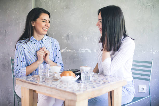 istock Girls In Cafe. Friends Drinking Coffee And Talking. 1204585447