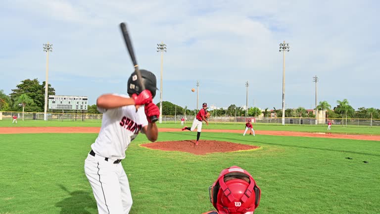 Teenage baseball player at bat pops up for the out